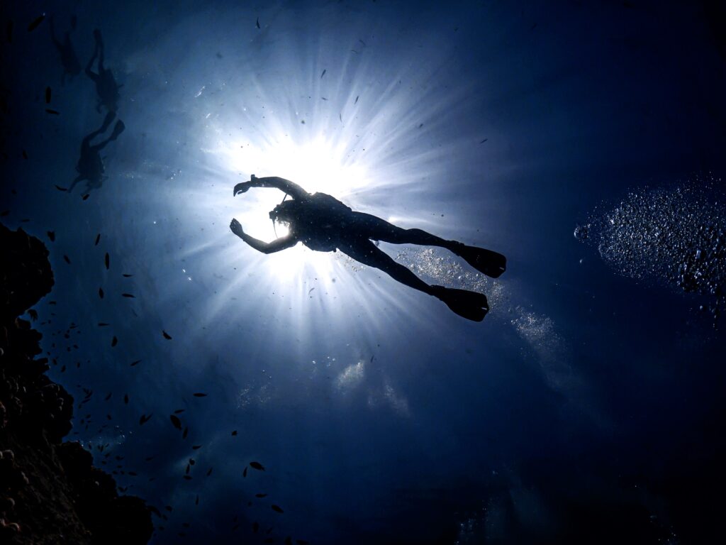 Pro SSI Scuba Diver exploring underwater coral reef, demonstrating advanced diving skills during an instructor training course.