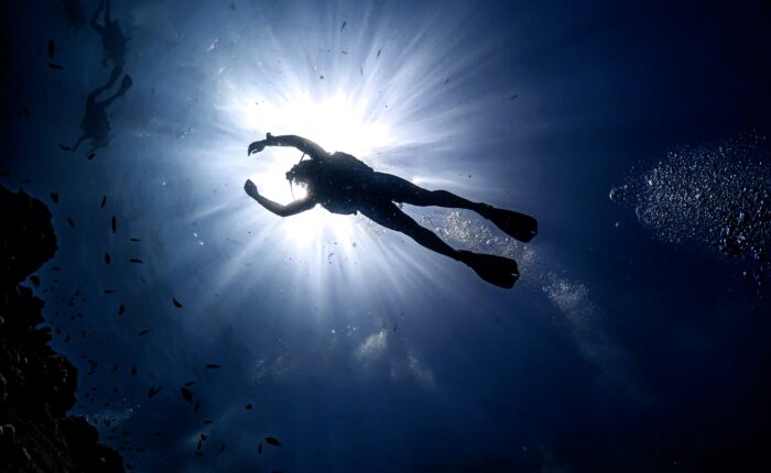 Pro SSI Scuba Diver exploring underwater coral reef, demonstrating advanced diving skills during an instructor training course.